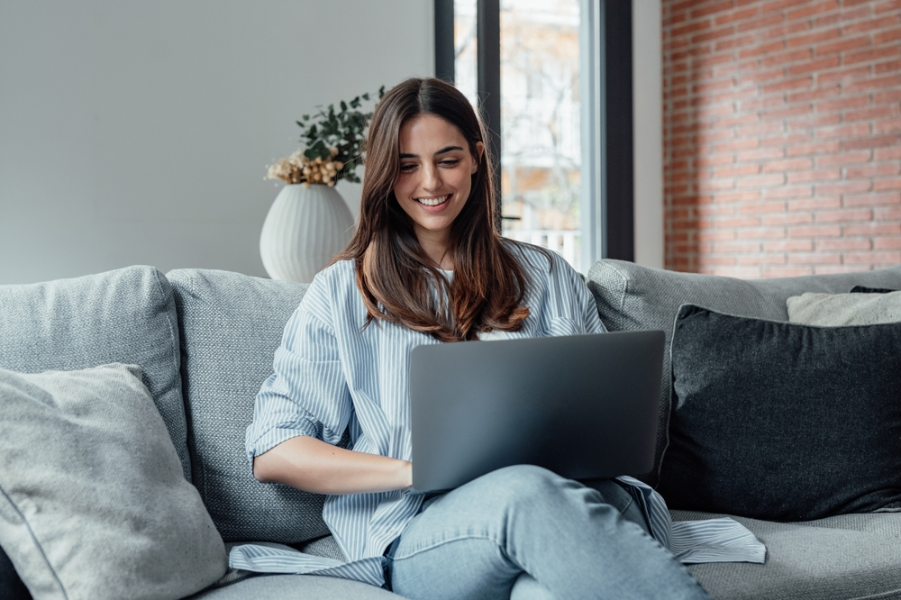 smiling woman shopping on laptop