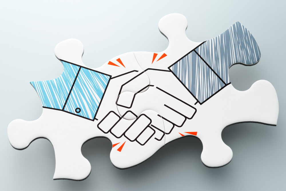 puzzle pieces fit together to form handshake to illustrate building trust