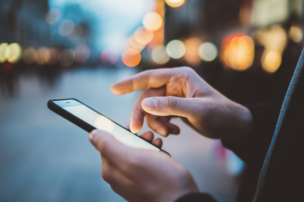 close up of hands using smartphone